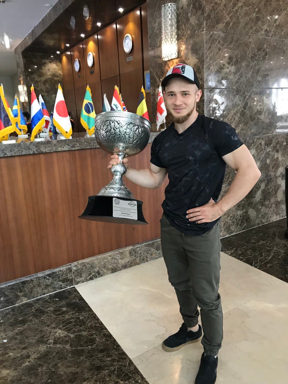 Holding a trophy at an international powerlifting competition